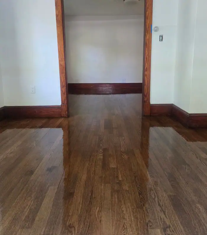 The same oak floor after: sanded, stained a warm brown and sealed to a gloss