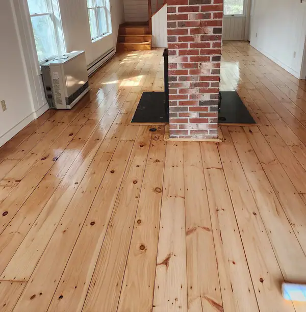 The same wide pine floor after: sanded and sealed clear