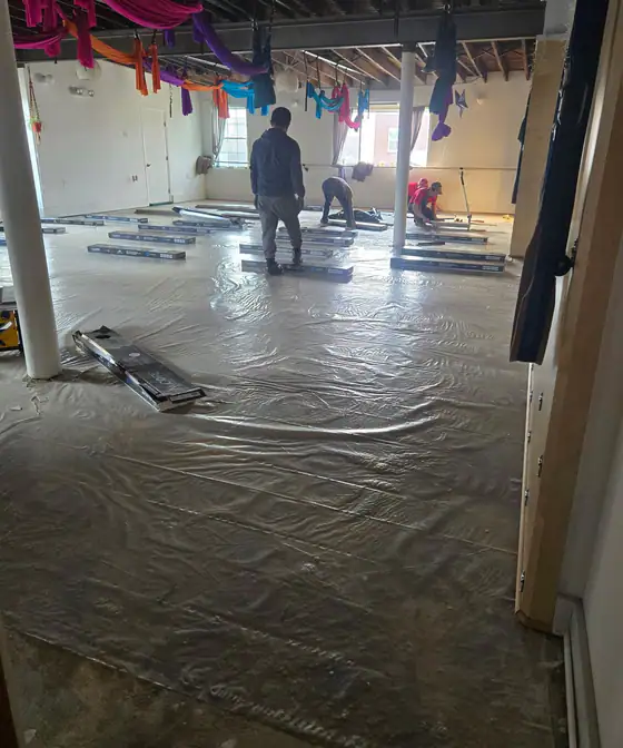 Studio floor during the install, crew laying new planks