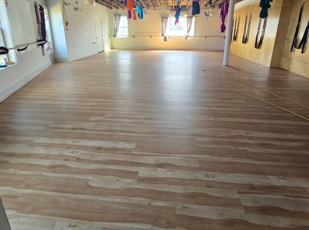 Studio floor mid-install with a table saw