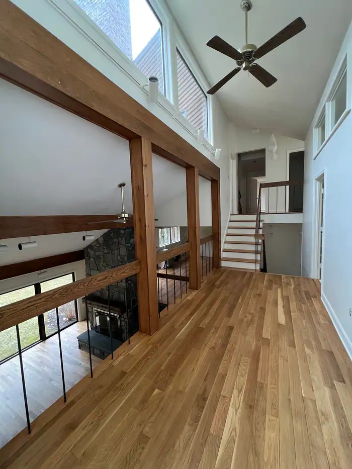 Light oak floor under timber beams with a stair to the loft