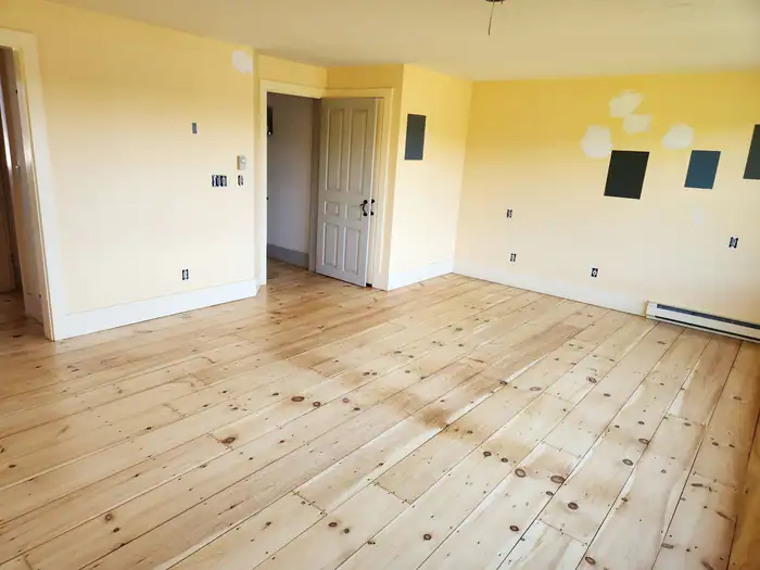Light pine floor sanded and sealed in a sunny yellow room