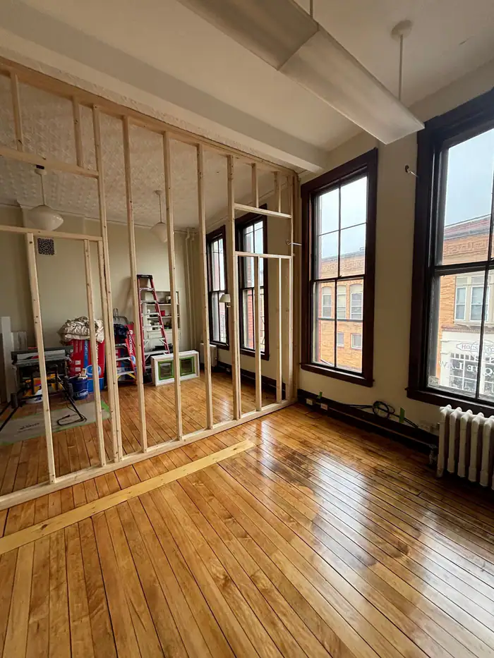 Glossy pine floor in a brick building during a renovation