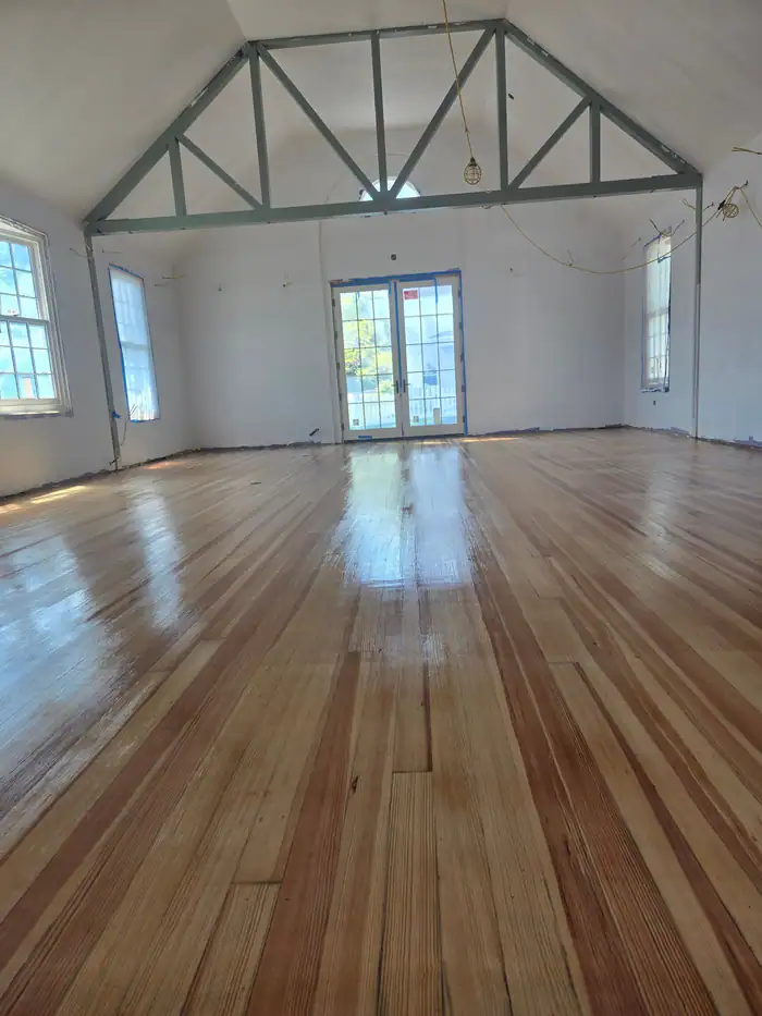 Large open hall with a freshly finished wood floor