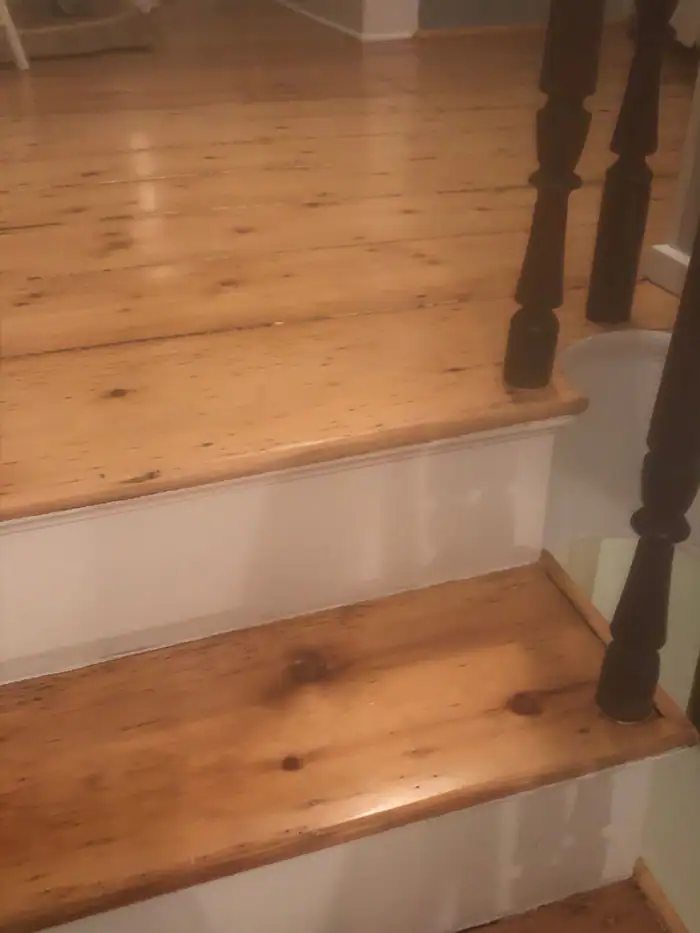 Oak stair treads refinished beside turned balusters