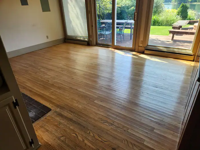 Oak floor in a sunny room with sliding doors to the patio