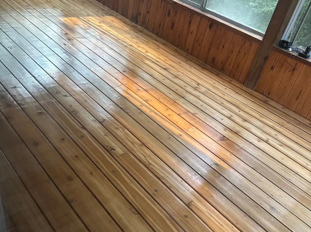 Wide pine boards refinished in a room with radiators and floral wallpaper