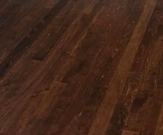 Close-up of a finished floor: dark stain, deep gloss