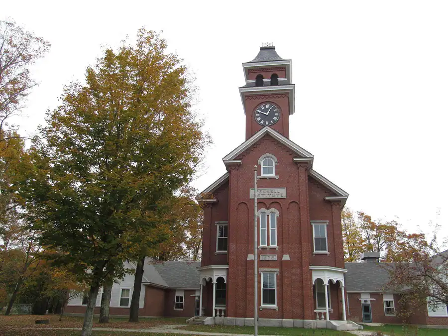 The brick Pennell Institute building with its clock tower on Main Street in Gray, Maine