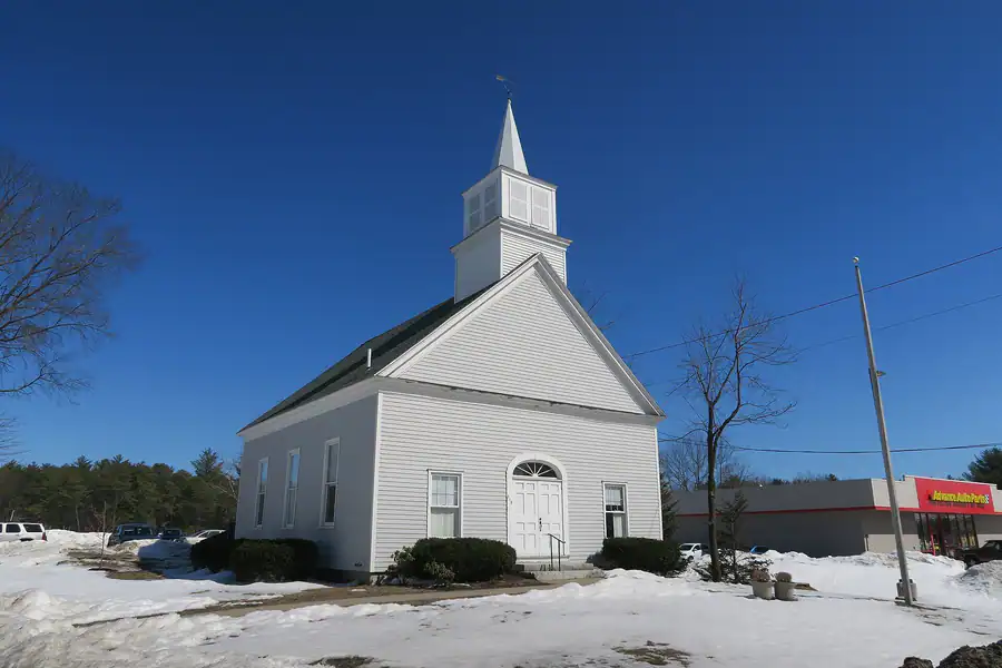 The Little Meetinghouse, a white church in North Windham, Maine, in winter